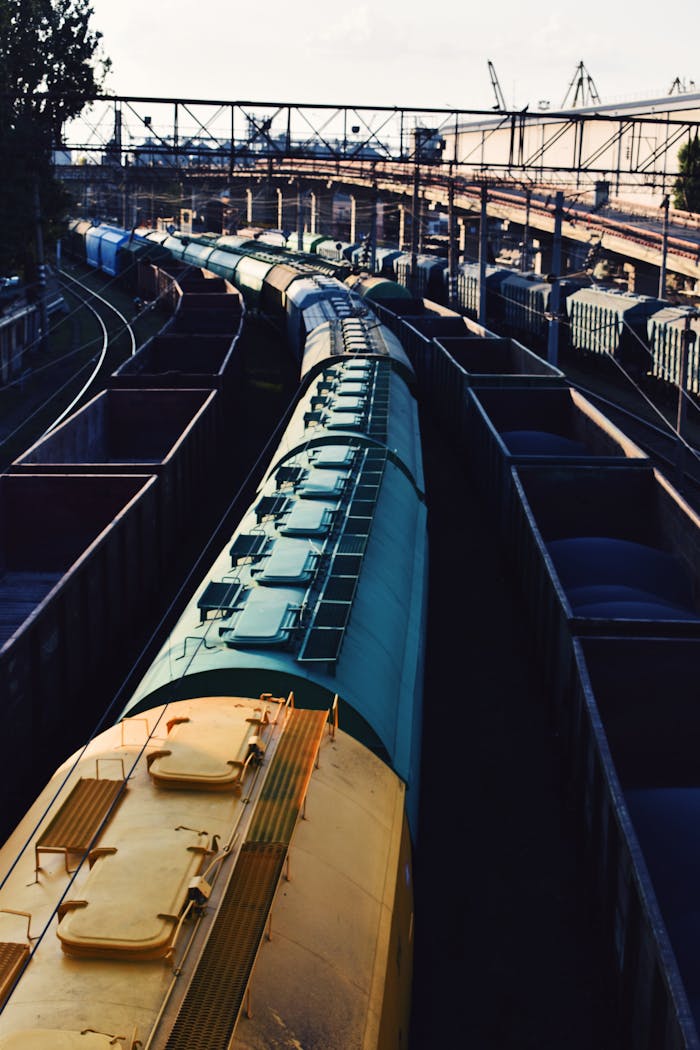 gallery-1 High angle view of freight trains at an industrial railway station with tracks and cargo containers.
