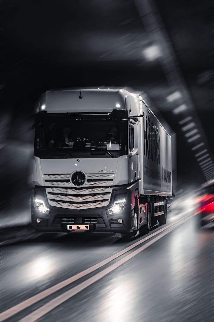 services-03 Mercedes-Benz Actros truck speeding through a city tunnel, capturing urban motion and energy.